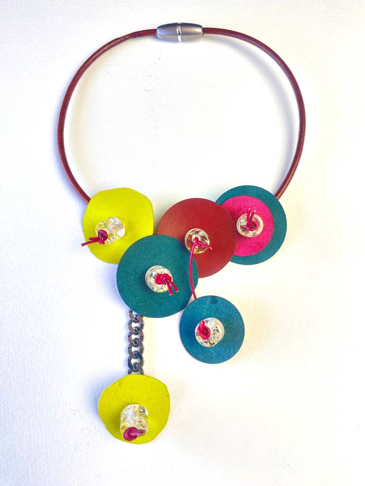 Leather disc necklace with chain for wholesale by Phyllis Clark