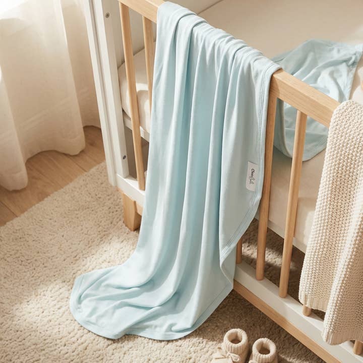 Stretchy Bamboo Baby Swaddle in Baby Blue Horizon for wholesale by Cleo & Bebe