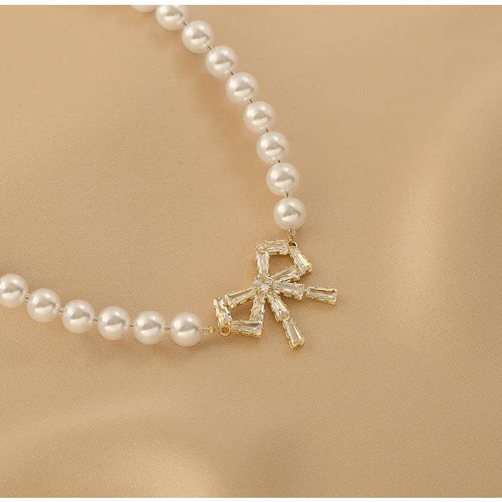 Gold Ladies Lux Fake Pearl Bowknot Necklace SKAJ015 for wholesale on Faire6
