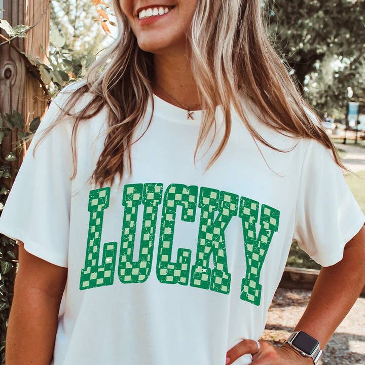 White Checkerboard LUCKY Graphic St Patrick Tee and other Purchase Wholesale patrick mercier seul camembert. Free Returns & Net 60 Terms on Faire trending on Faire.