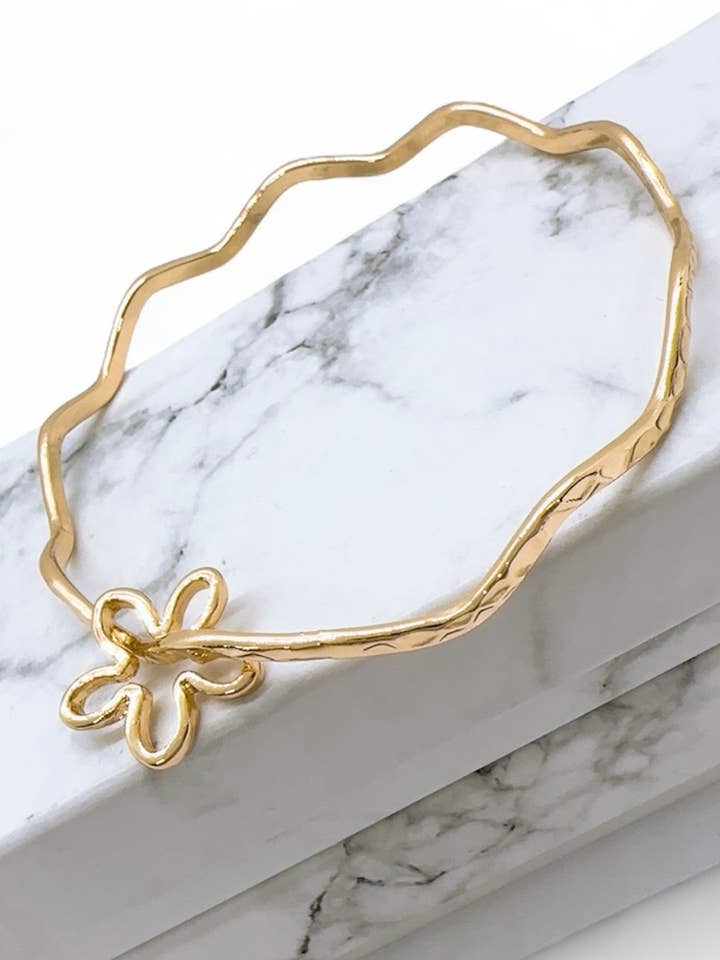 Wavy Bangle with Flower Charm for wholesale by Anela's Jewelry