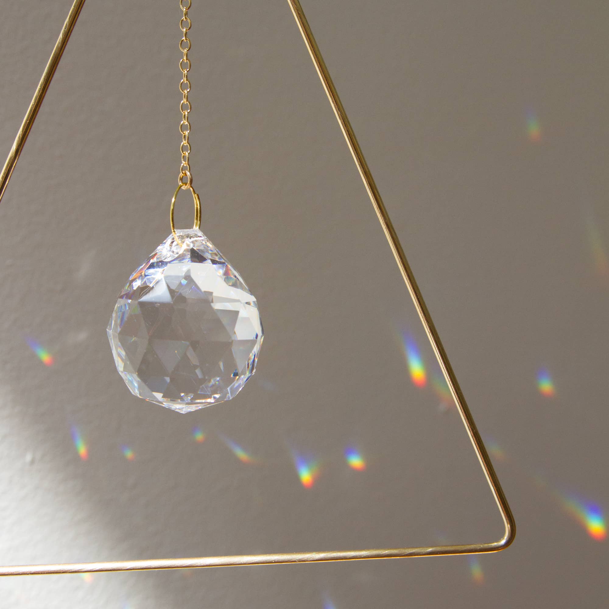 Sol Proaño - Wholesale Suncatcher - Prisma 21 Triangle Brass Suncatcher1