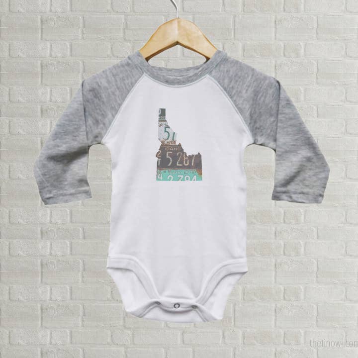 Idaho Baby Onesie | Romper | Vintage License Plate Art for wholesale by Juniper & Spruce