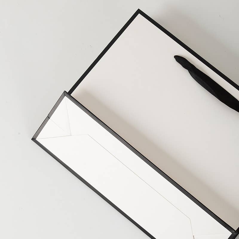 ByHome - Venta al por mayor Bolsas de celofán - Bolsa de regalo blanca con borde negro y papel de seda gratis2