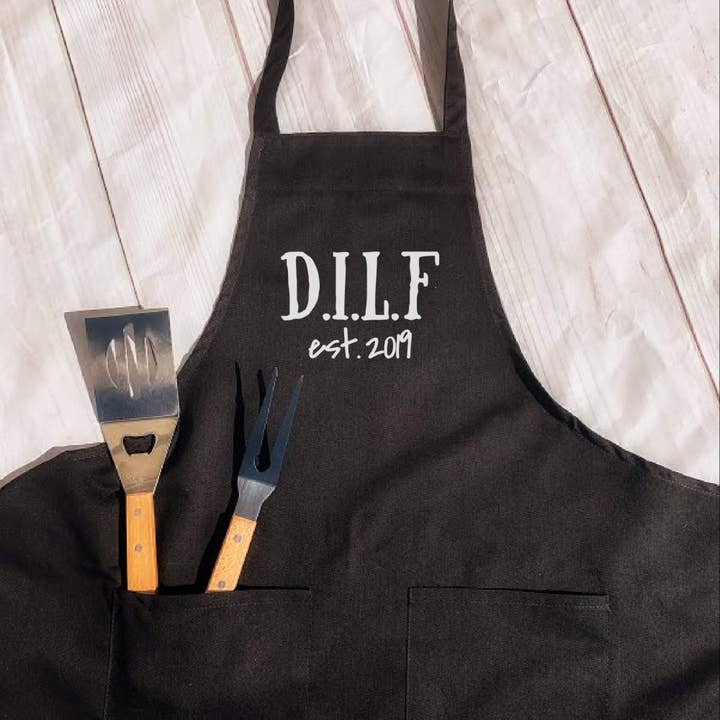 Dilf Apron With Year, Gift For Dad, Fathers Day Gift for wholesale by Dirty Grove by Hazel Grove Customs