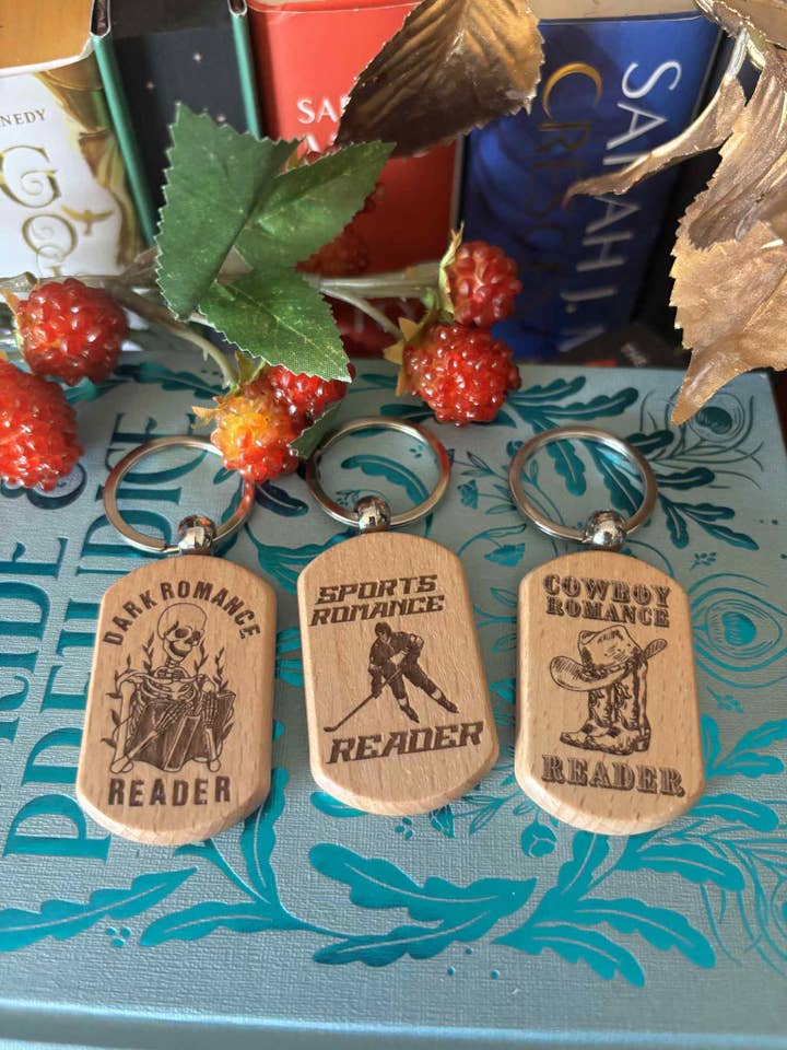Wooden laser engraved book themed keychain for wholesale by Cryptid Creations