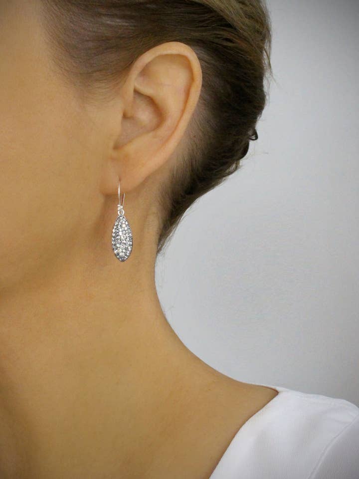 Petite rhodium plated earrings with grey pavé drops for wholesale by DIGE DESIGNS