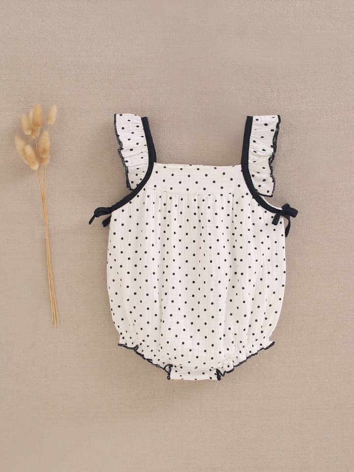 Witte babymeisjesromper met stippen en zwarte strikjes voor wholesale door Dadati