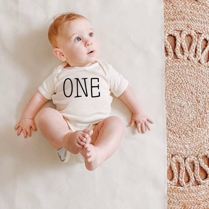 One | Birthday | 100% Cotton Baby Bodysuit or Tee for wholesale by Wildflowers + Cotton