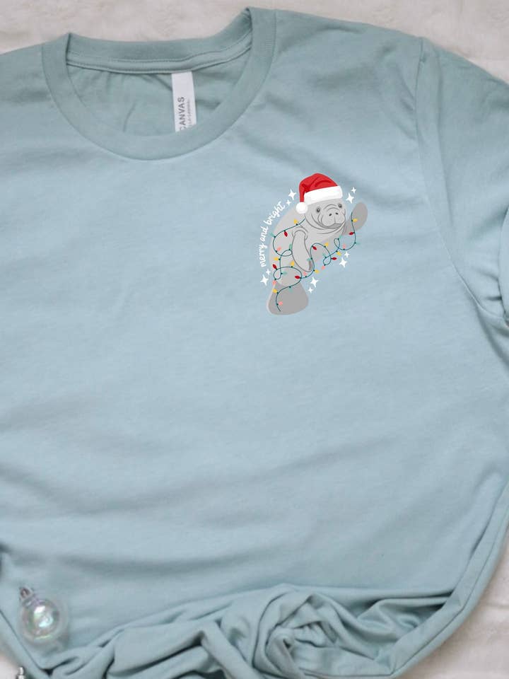 Christmas manatee t-shirt, merry and bright holiday manatee for wholesale by Sunshine Collective