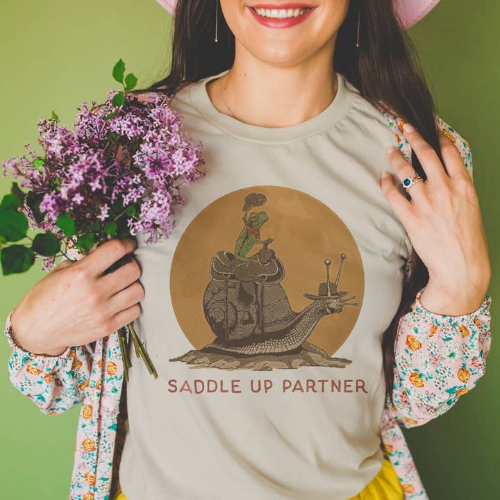 Saddle Up Partner Snail and Frog Cowboy Unisex Shirt for wholesale by Cluster Funk Studio