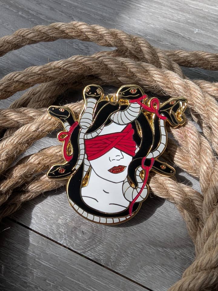 Medusas gaze Shibari enamel pin, rope label badge for wholesale by Geek and Artsy
