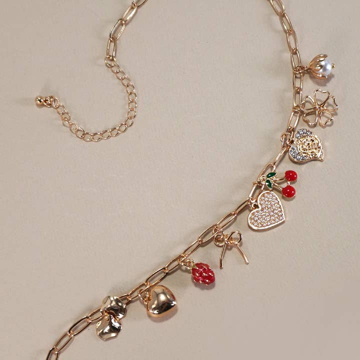 Gold MULTI CHARM BOW CHERRY HEART NECKLACE | 80N1190 for wholesale on Faire1
