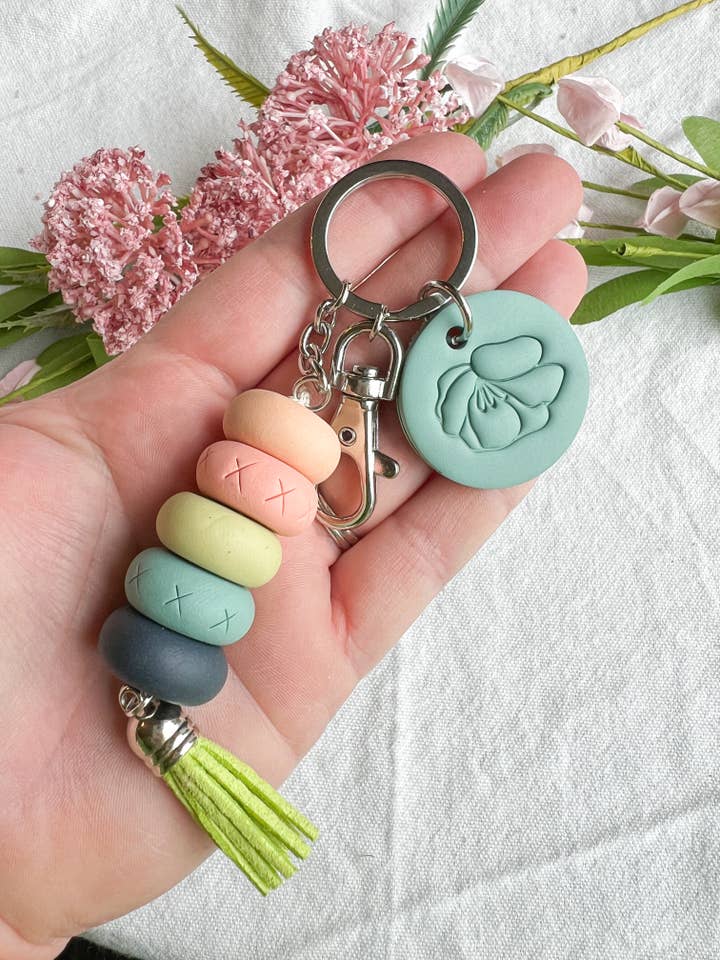 Turquoise and Orange Beaded Flower Stamp Clay Keychain for wholesale by Morning Dew Designs