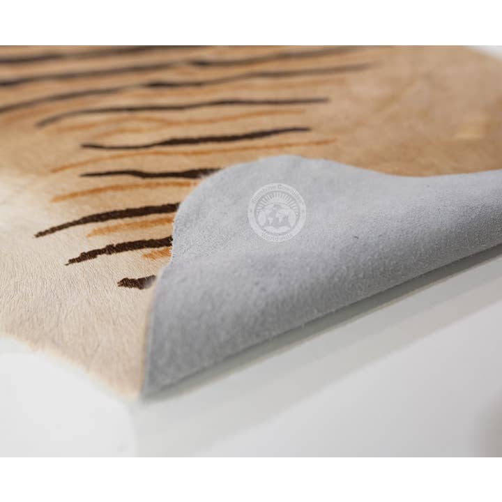 Brown Wild Zebra Stripes on Beige Cowhide Rug for wholesale on Faire3