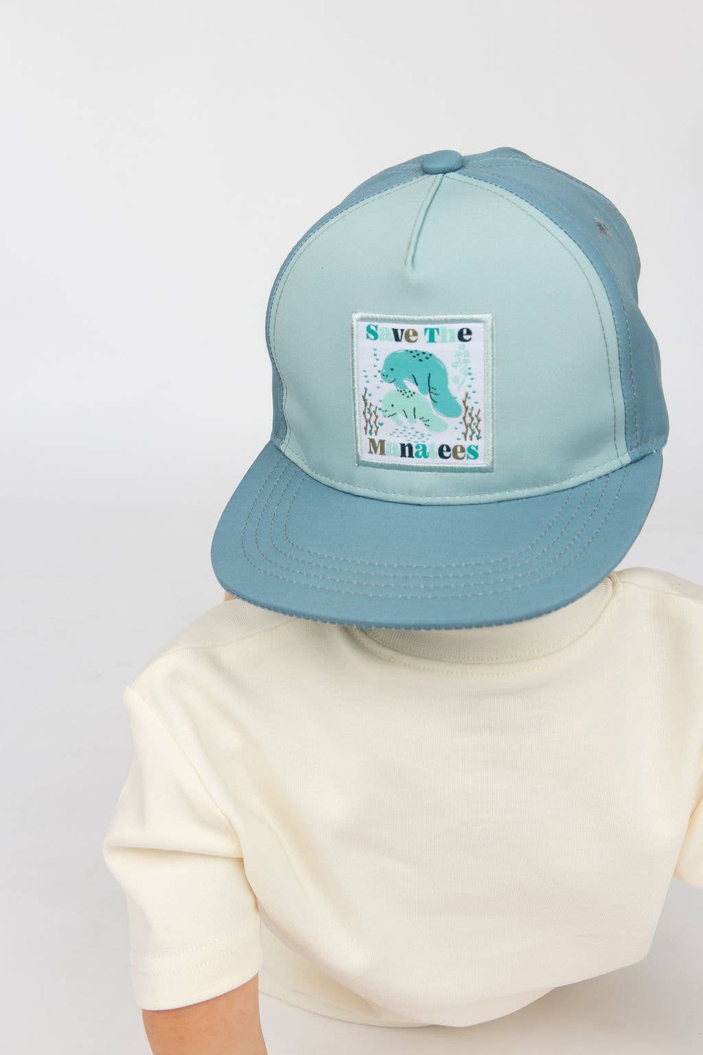 Blue Multi Save the Manatees Ocean Conservation Kids Snapback Hat for wholesale on Faire1