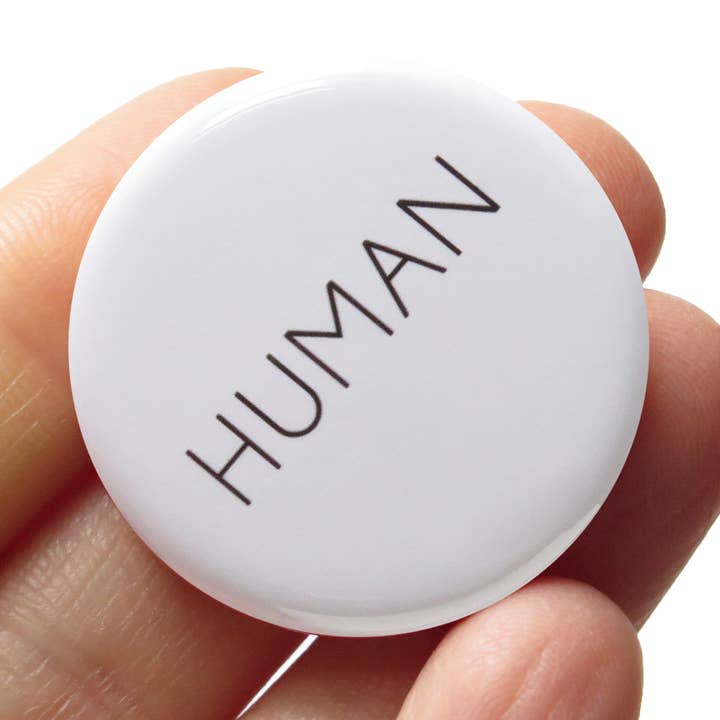 HUMAN 1.25" Pinback Button Inclusive Pin for wholesale by Word For Word Factory
