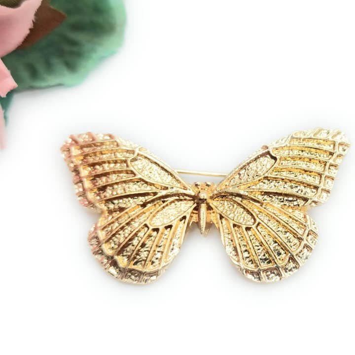 Butterfly Flamingo sjalebroche · Brill guld for engroshandel hos BRANDELIA