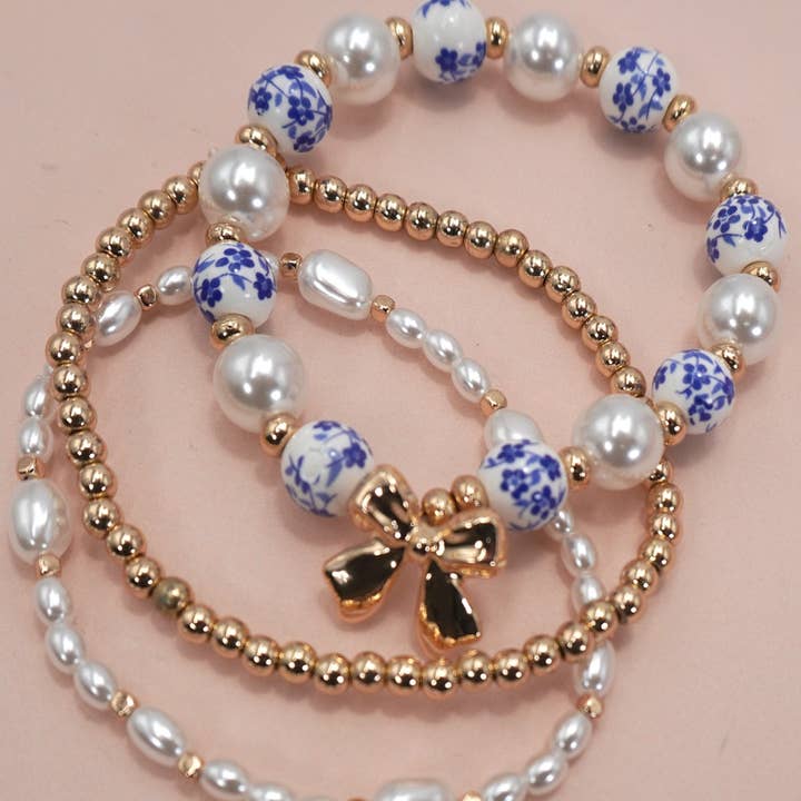 BLUE CERAMIC PORCELAIN BOW MULTI LAYER BRACELET | 80B1333 and other Purchase Wholesale bombay. Free Returns & Net 60 Terms on Faire trending on Faire.