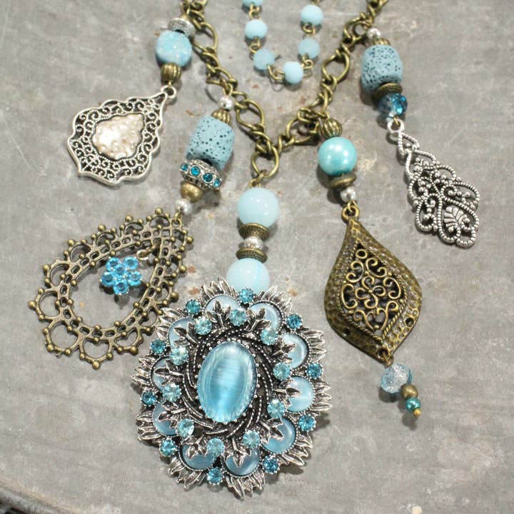 The Primitive Peddler, Inc. - Wholesale Pendant/Charm Necklace - Embellishments Of Bronze & Silver Charming Blue Pendant Layered Necklace