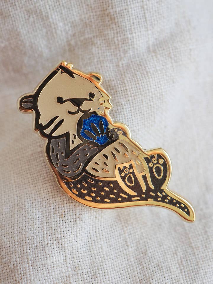 Zeeotter - Blauwe Schelp - Reversspeldje voor wholesale door LanaBetty