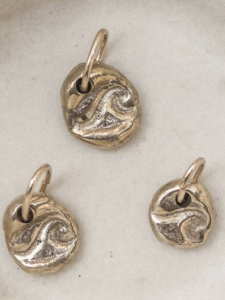 wave charm | organic stamped charm | bronze for wholesale by Emily Hartwell