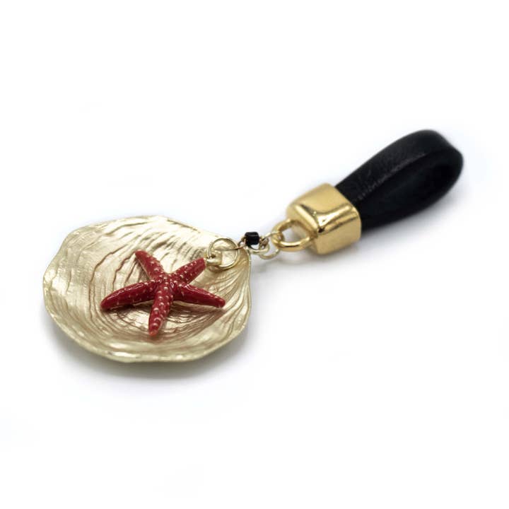 Golden shell with red starfish pendant for wholesale by FATES, style with a story
