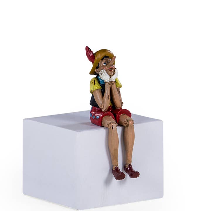 Antiqued Sitting Pinocchio Figure for wholesale by McGowan & Rutherford Ltd