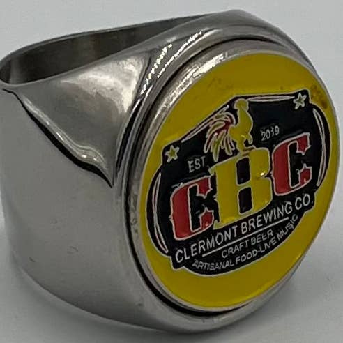 Clermont brewing co. for wholesale by Brassa Inc. The deCAPitator ring bottle & can tab opener