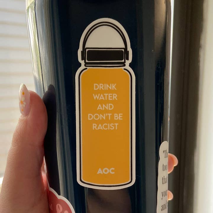AOC "Drink Water and Don't Be Racist," Sticker, Yellow for wholesale by Thrifty and Nifty Goods