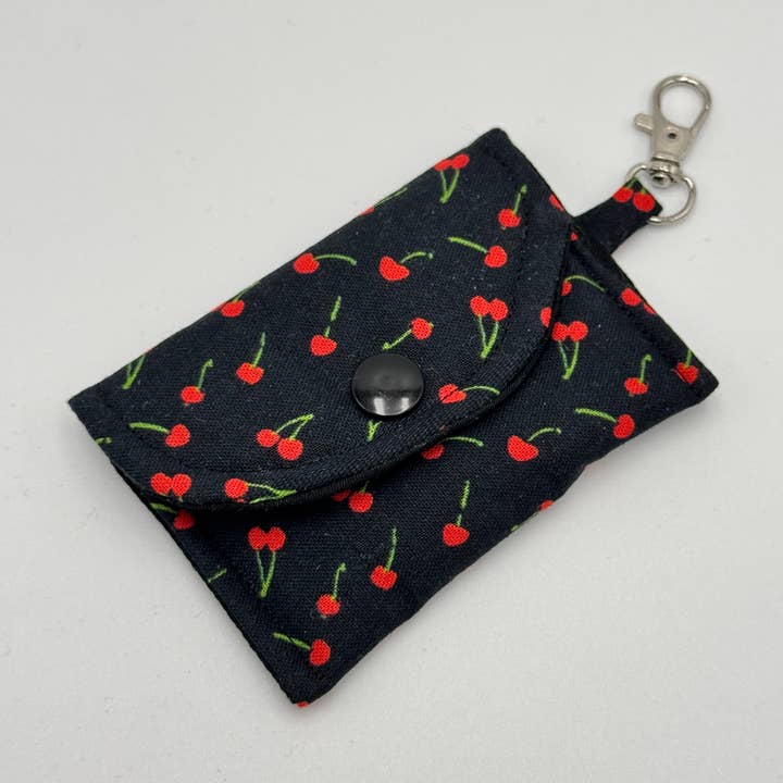 Black & Cherry Fabric Air Pod Case Keychain, Earbud Case for wholesale by The Sticker Lab
