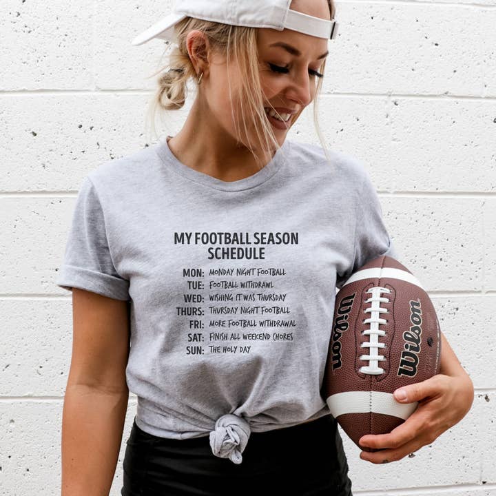 T-shirt con grafica divertente My Football Season Schedule per la vendita all'ingrosso da parte di Trendznmore - Modern Graphic Apparel