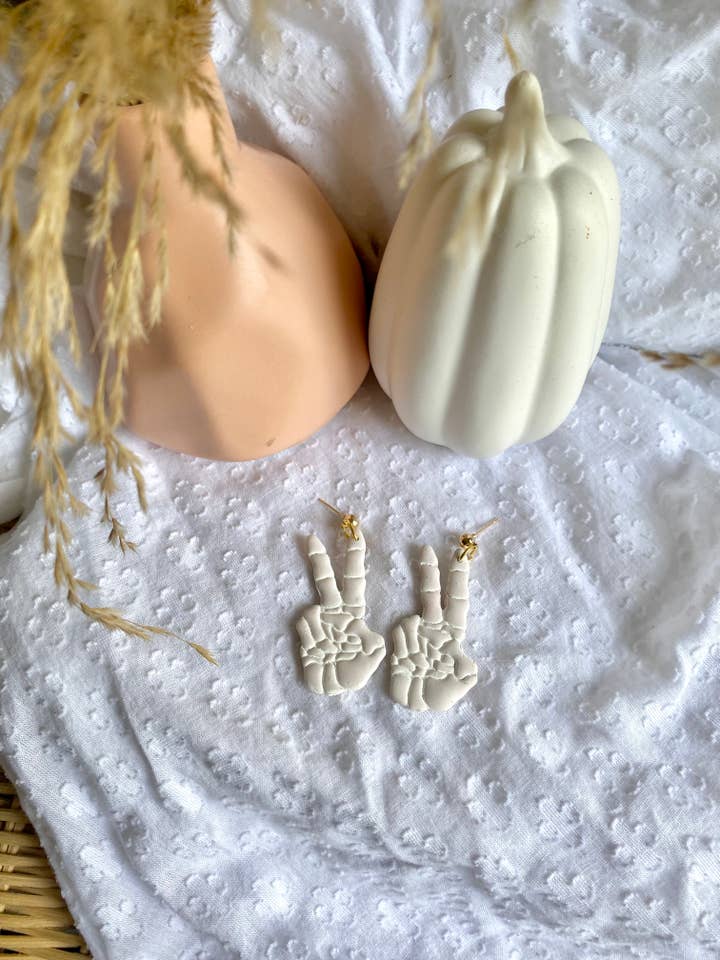 Skeleton hand peace sign earrings for wholesale by Terra Made