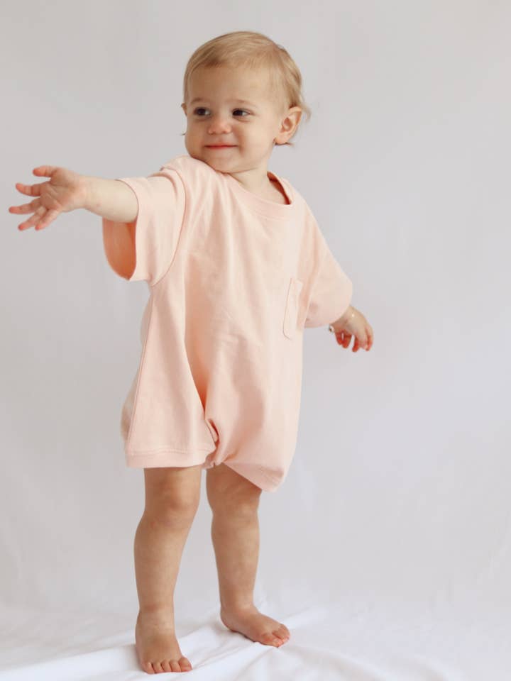 Cory Pocket Romper in Peach Powder for wholesale by Winnie + Crew