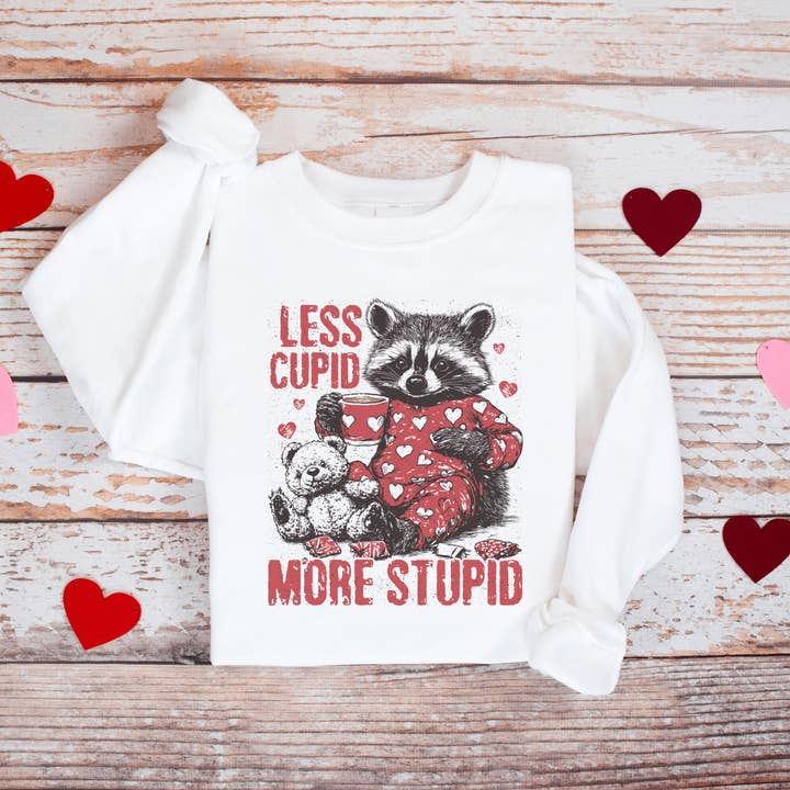 Swain Co. - Wholesale Graphic Sweatshirt - Women's - Less Cupid, More Stupid Anti-Valentine’s Day Raccoon Sweatshirt