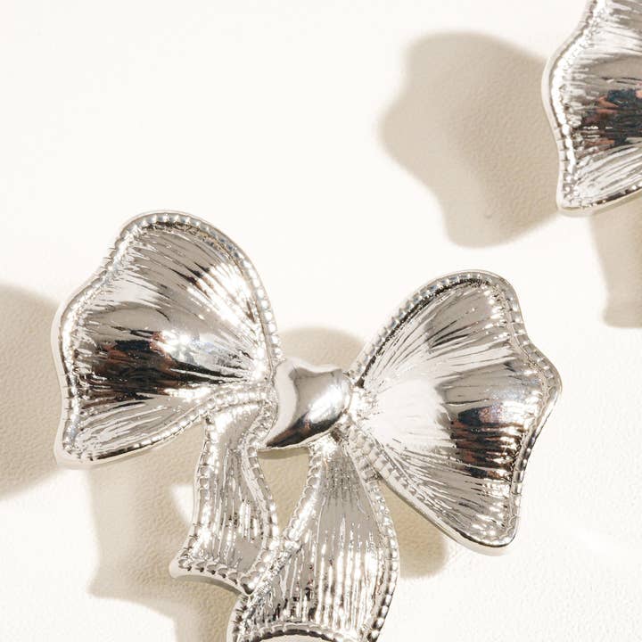 Glint Silver Glitter Bow Earring for wholesale on Faire