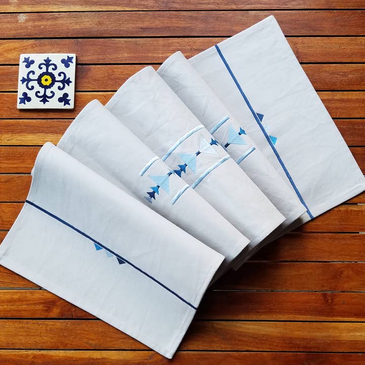 Beige cotton table runner embroidered with blue triangles for wholesale by Indigostep