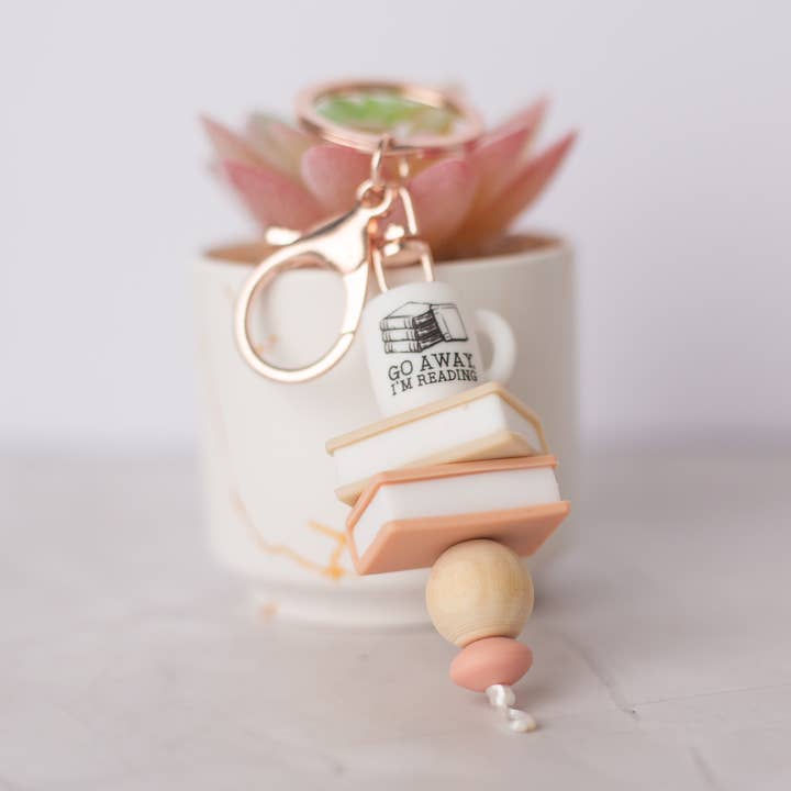 Go away I'm reading Keychain for wholesale by Darling Doe Designs