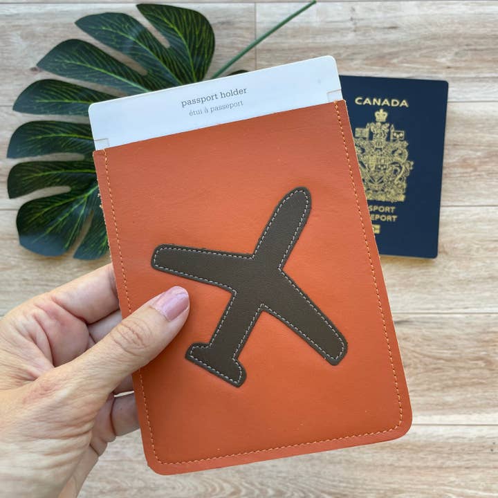 Custodia per passaporto in pelle, arancione con motivo aeroplano per la vendita all'ingrosso da parte di Mally Designs