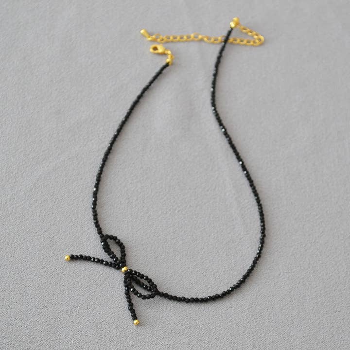 Revelari - Wholesale Beaded/pearl necklace - Black Beaded Necklace with Gold Bow Detail3