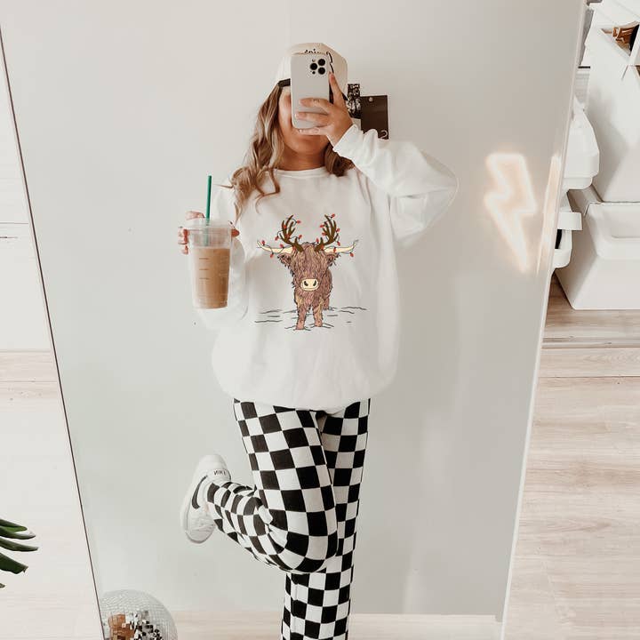 Christmas lights highland cow design on tee or sweatshirt for wholesale by Gunpowder and lace wholesale