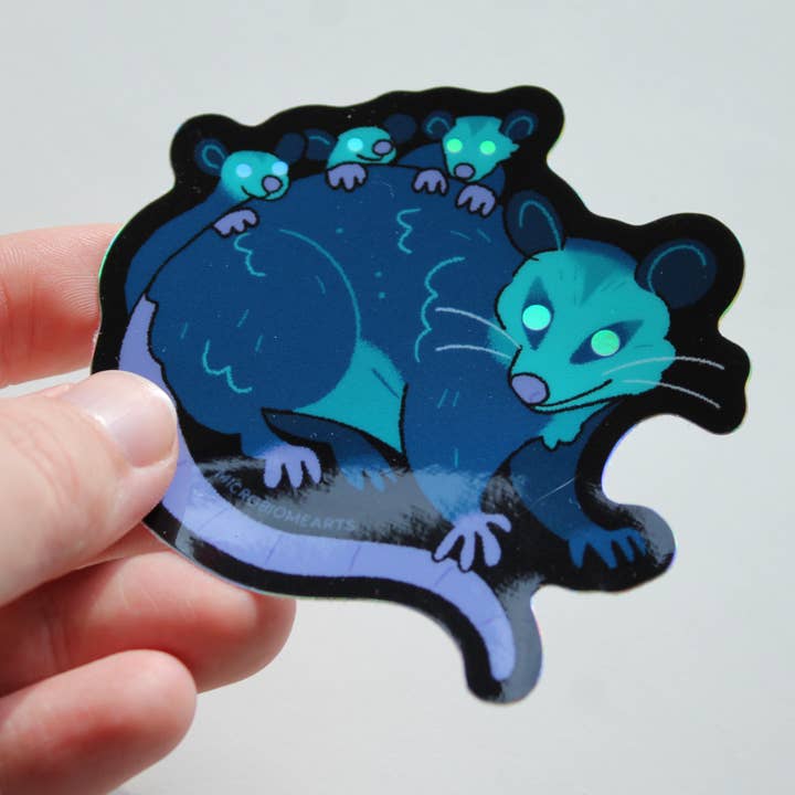 Glowing Eye Opossums Holo 3.5” Sticker for wholesale by Microbiome Arts
