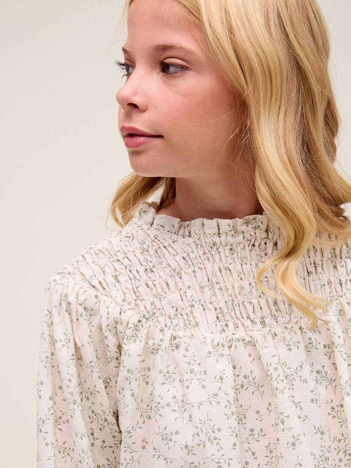 Natural Girl's blouse in cream color with green floral print for wholesale on Faire1