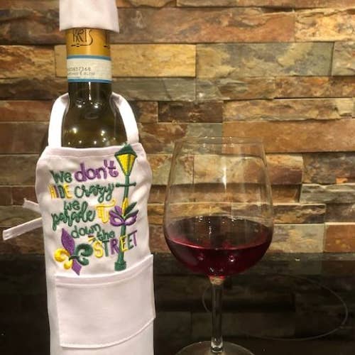 Wine Bottle Apron- Mardi Gras We Don't Hide Crazy for wholesale by All Aboard Party Headquarters