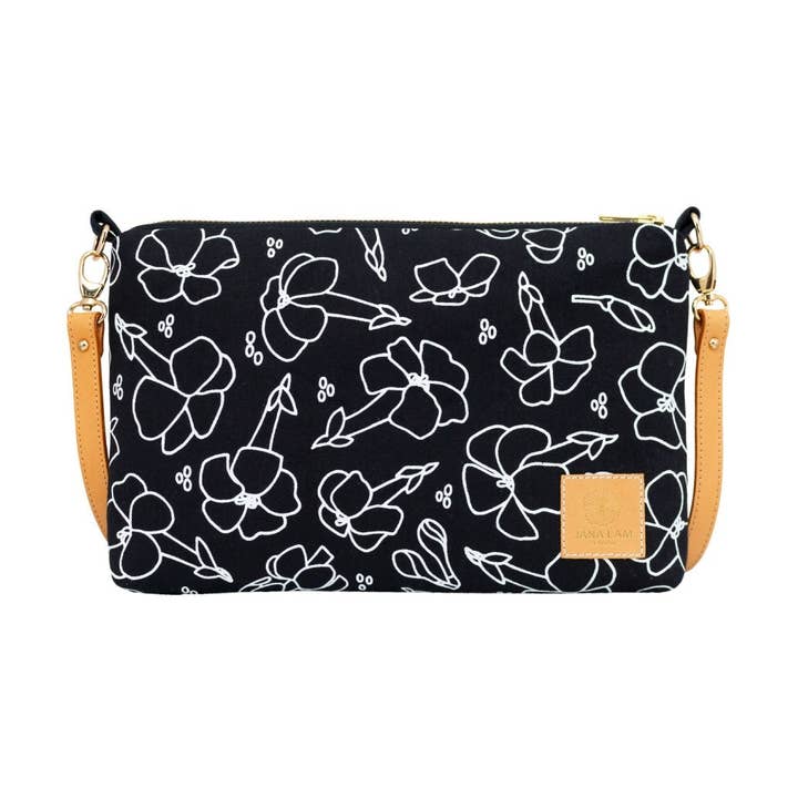 Schmale Umhängetasche mit Reißverschluss • Puakenikeni • Weiß auf schwarzem Stoff für den Großhandel von Jana Lam