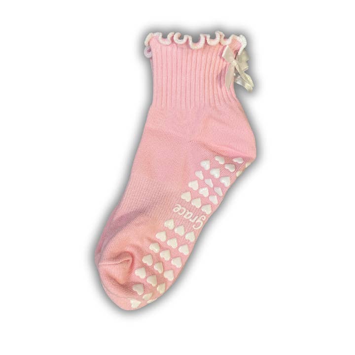 Light pink ruffle grip socks with white bow  for wholesale by MollyGraceGripSocks