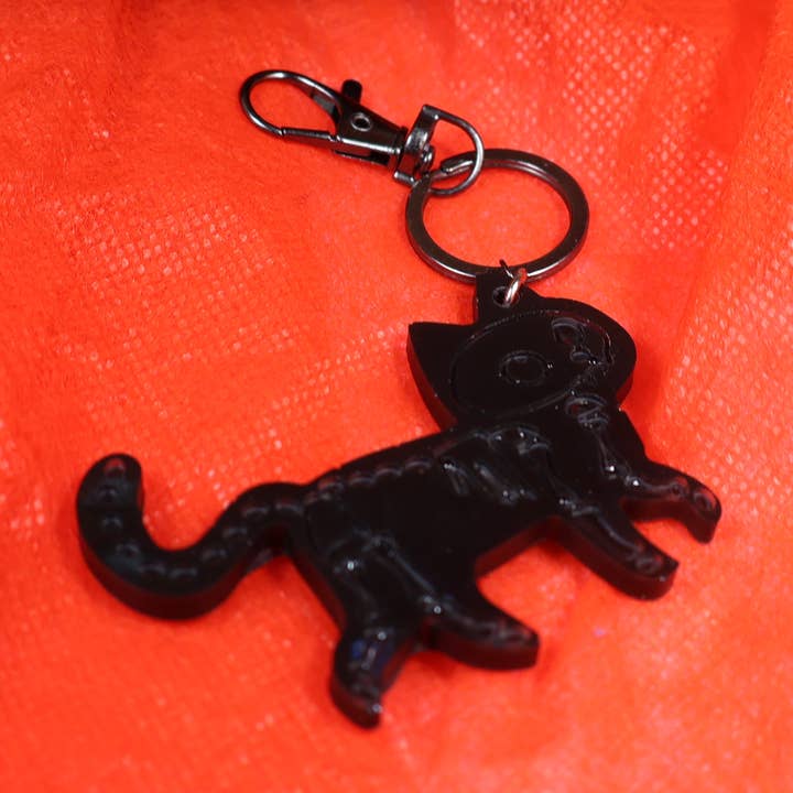 Handmade Black Cat Skeleton Keychain – Unique Epoxy Resin Halloween Gift by KIZIMA USA | Spooky Bag Charm | Fun Collectible Accessory for wholesale by KIZIMA