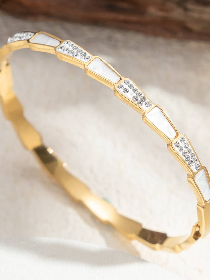 Gold bangle bracelet in stainless steel with shimmering white mother-of-pearl for wholesale by COSMOS