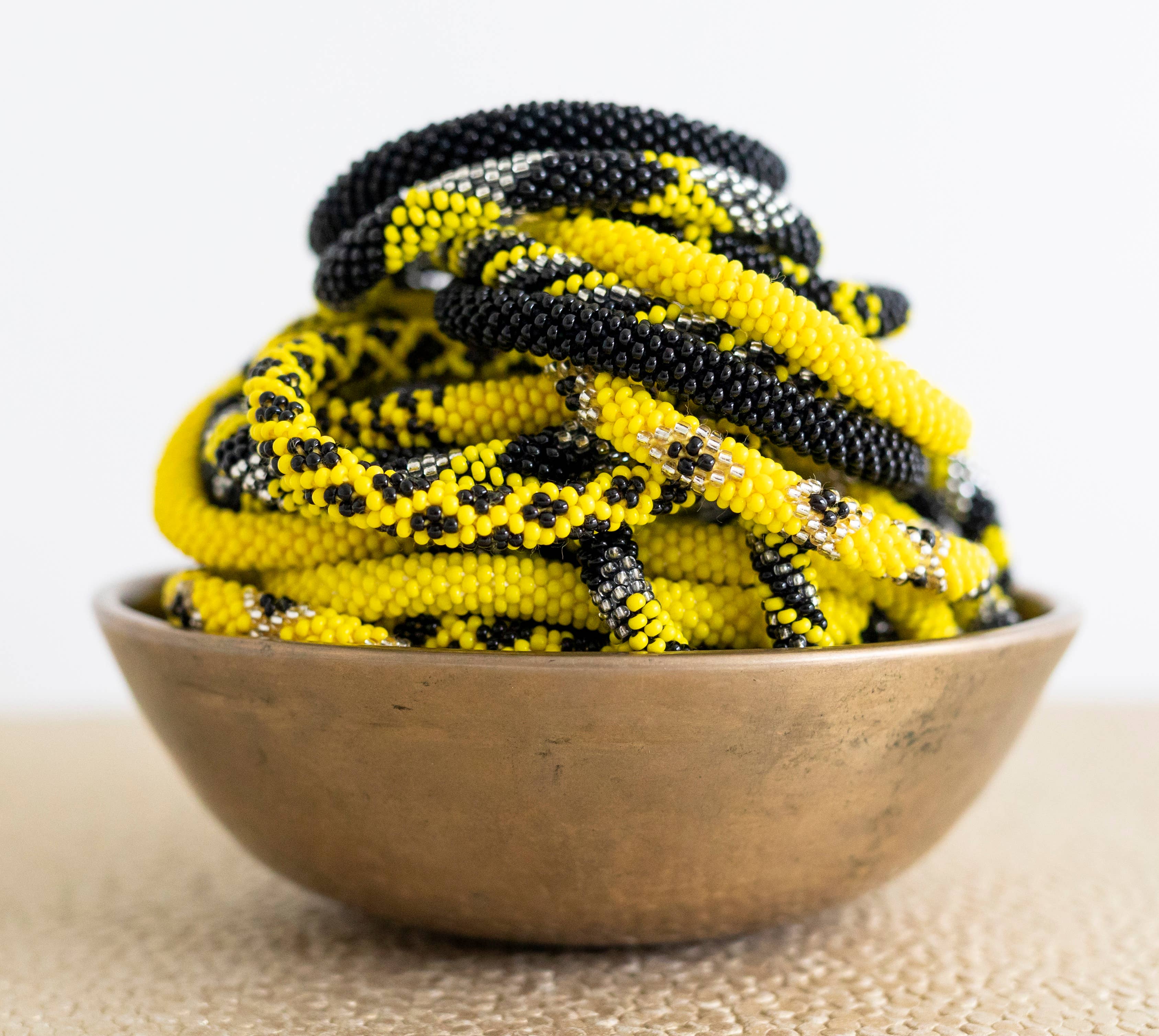 Aid Through Trade - Wholesale Jewelry Set - Roll-On® Game Day Bracelet Black and Yellow - Set of 121