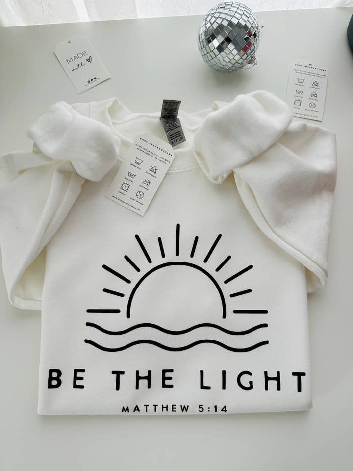 Designs by MJ - Wholesale Graphic Sweatshirt - Women's - Be The Light Christian Sweatshirt